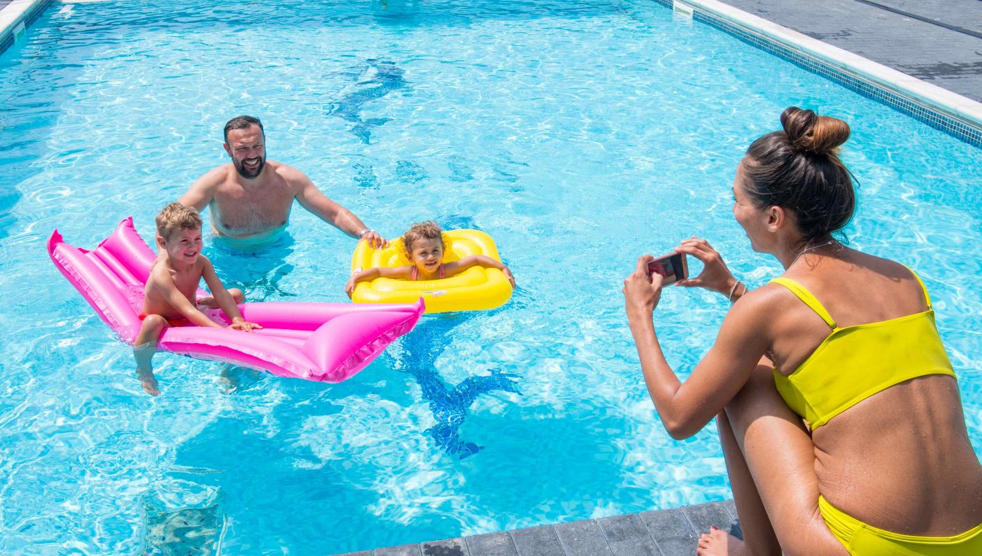 Family around outdoor pool in Woolacombe Sands Holiday Park in North Devon