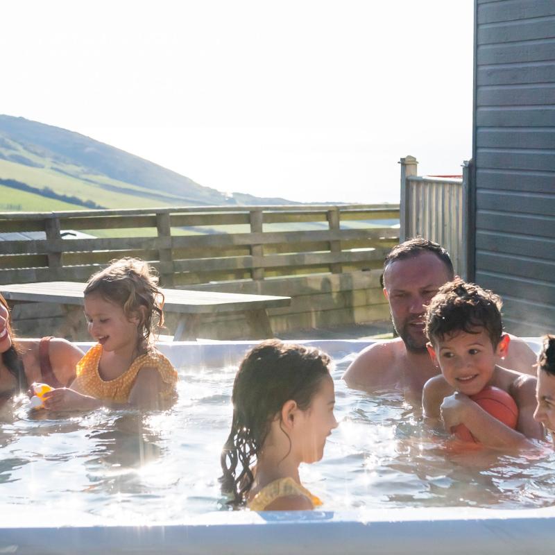 Woolacombe Sands Holiday Park family relaxing in the hot tub