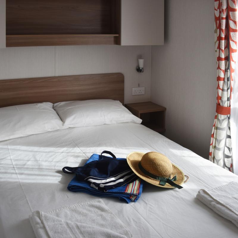 The double bed inside one of Woolacombe Sands Holiday Park's Atlantic Gold Caravans