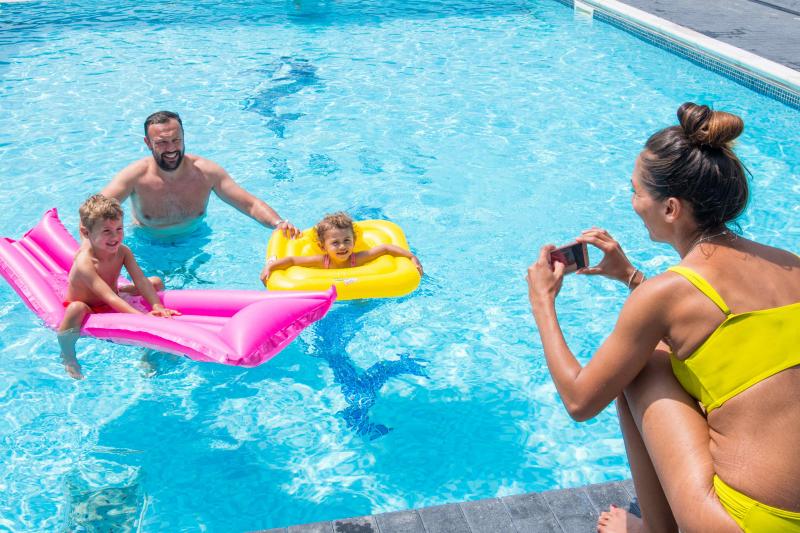 Family around outdoor pool in Woolacombe Sands Holiday Park in North Devon