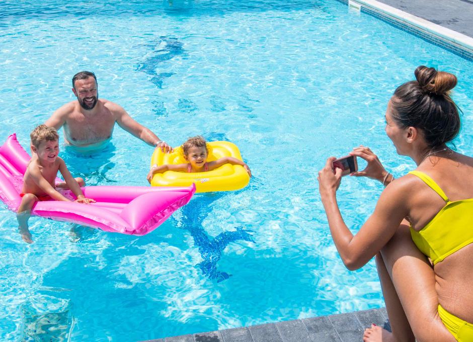 Family around outdoor pool in Woolacombe Sands Holiday Park in North Devon