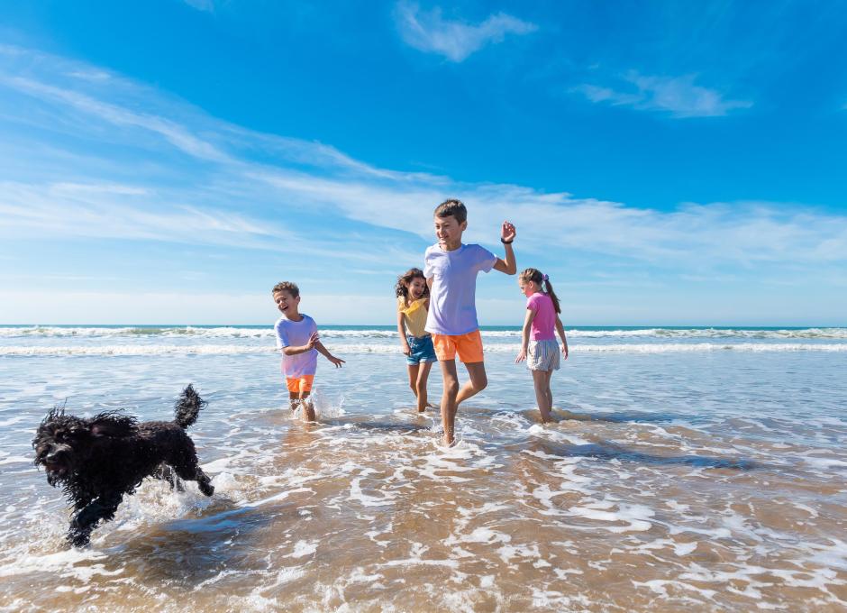 Woolacombe Sands Holiday Park Children running on the beach with dog