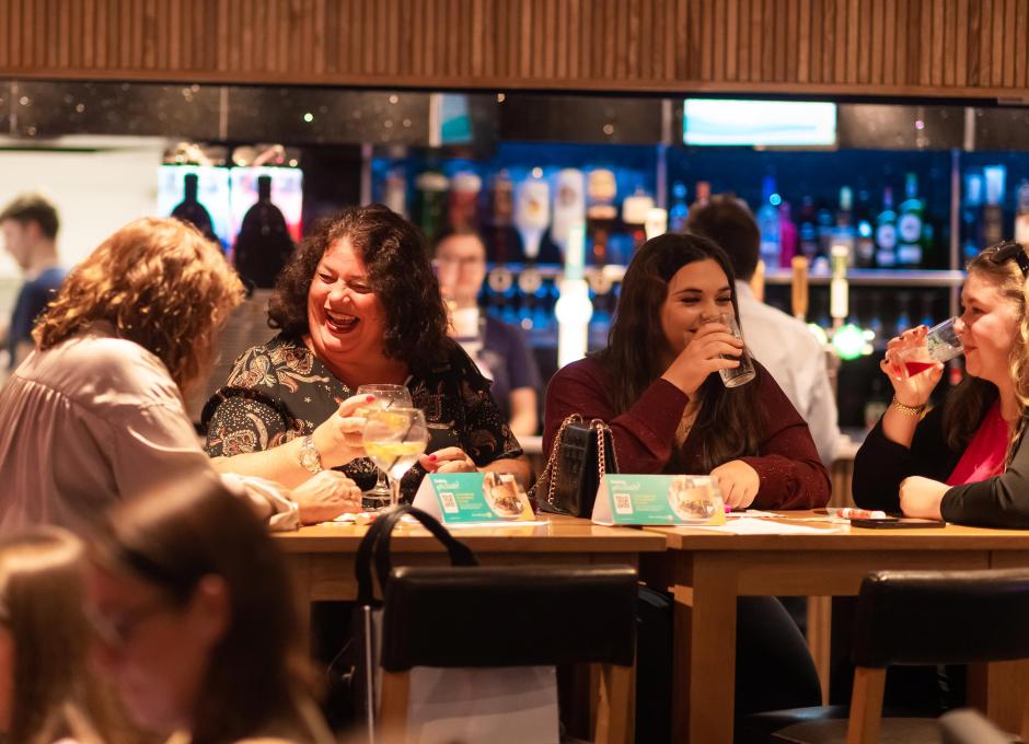 Guests enjoying drinks in the bar area of the Woolacombe Sands Holiday Park clubhouse