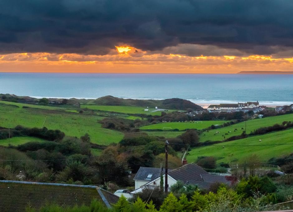 The view from the Outdoor Swimming Pool at Woolacombe Sands Holiday Park at Sunset