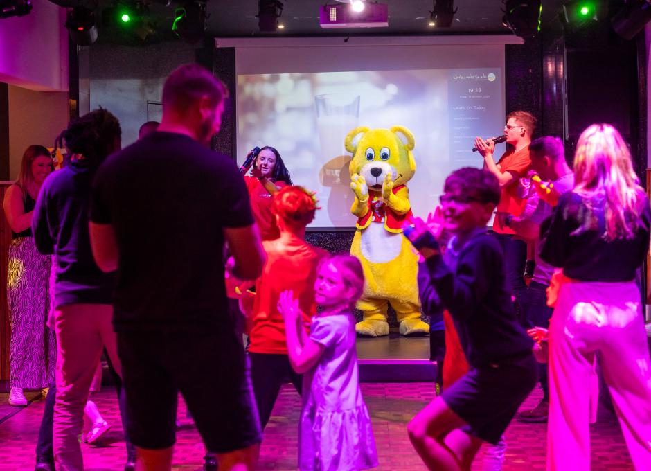 Staff and guests dancing at a UV Party inside the Woolacombe Sands Holiday Park Clubhouse
